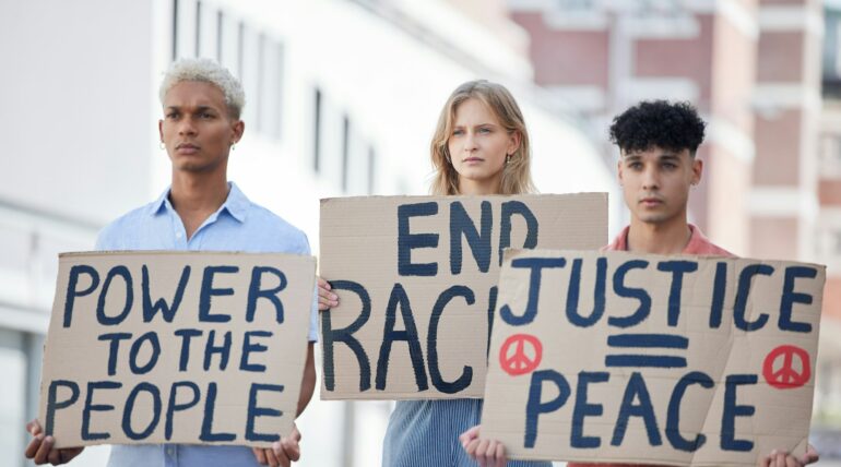 Protest, crowd and poster of peace, racism and justice in city street rally, fight and human rights