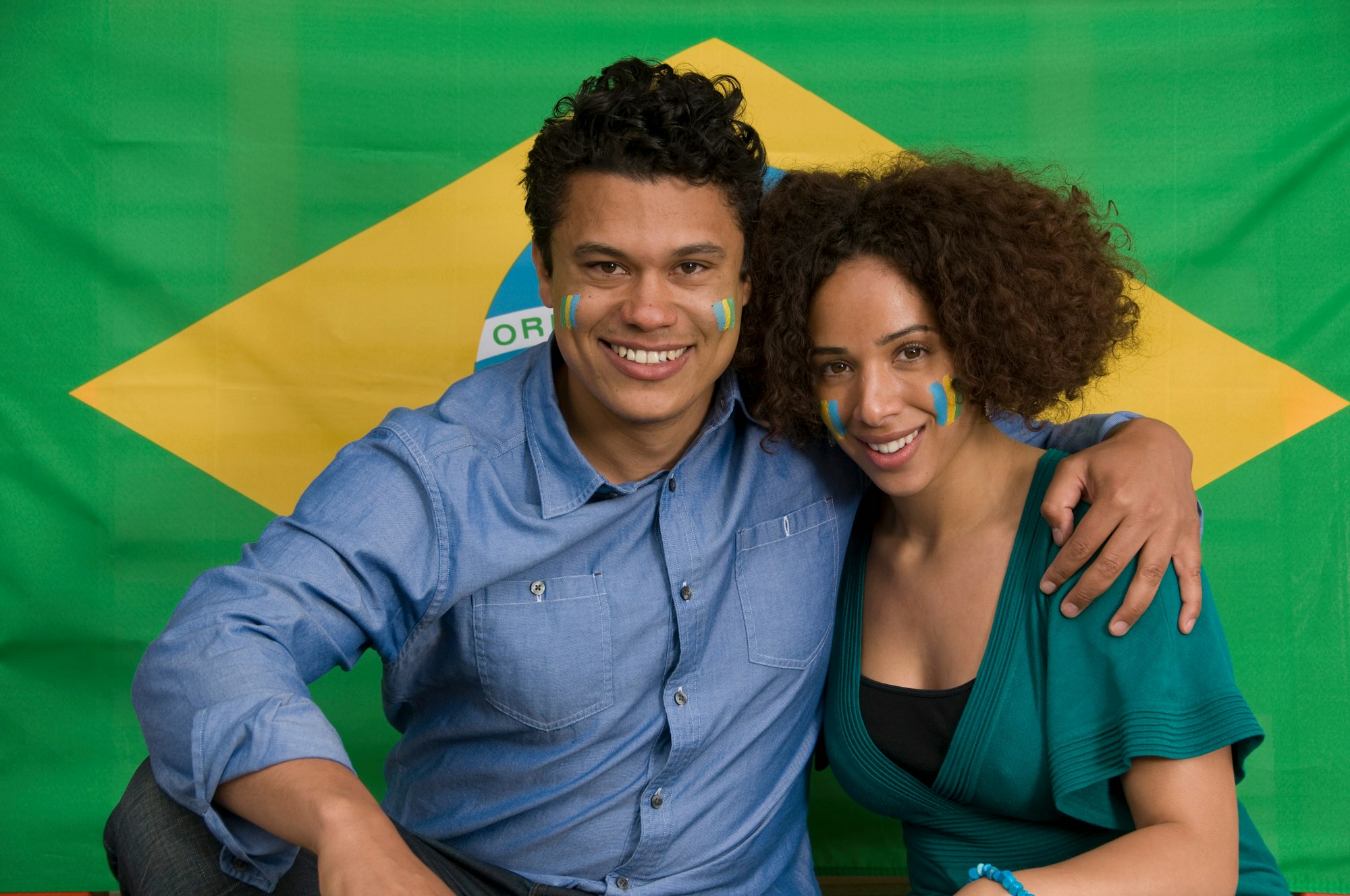 Couple smiling with Brazilian flag